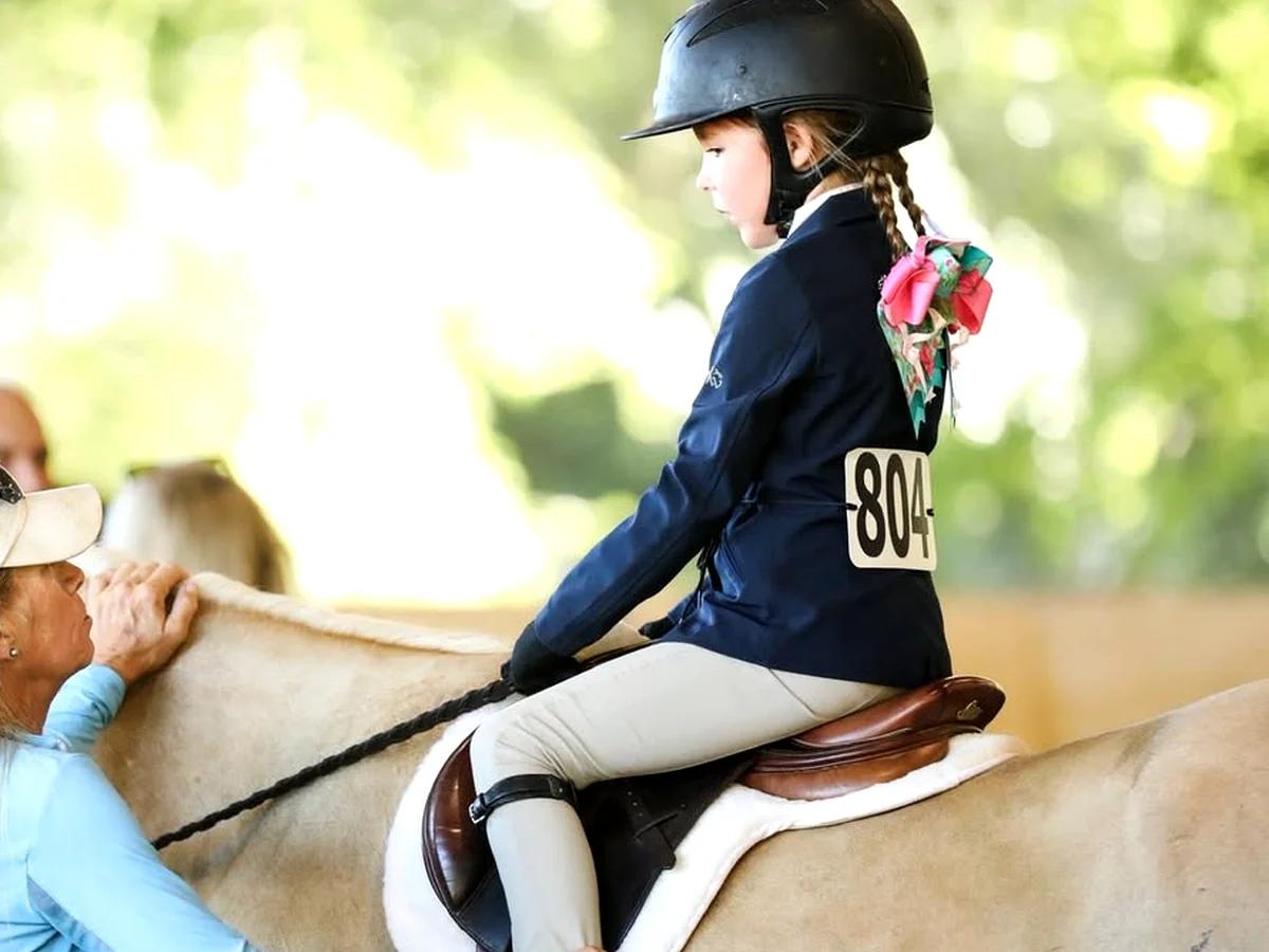 Young student rider learning basic horsemanship on a pony.